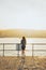 Vertical back view of a young female enjoying sunset at St Ives harbor, England, United Kingdom