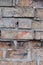 Vertical background old masonry of red brick. Cracks, peeling, voids