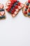 Vertical background with peanut butter toasts with seasonal berries