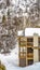 Vertical Balconies and chimney of homes against mountain covered with snow in winter