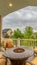 Vertical Balcony with chairs around table with fire pit against homes and mountain view