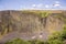 The vertical basalt walls surrounding the Phantom Falls valley, turkey vulture circling above, North Table Mountain Ecological