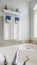 Vertical Bathroom interior with agleaming bathtub beside a large arched window