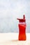 Vertical Beach Sand Background With Red Beverage and Shallow DOF