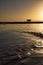 Vertical of Bembridge beach and its lifeboat station in the Isle of Wight against the sunset sky