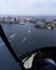 Vertical bird\\\'s-eye shot of a Sydney cityscape photographed from a helicopter window