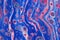 Vertical blue tubes are filled with neon pink cells in this abstract background.