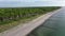 Vertical climb and left turn above baltic sea on an empty sandy beach,  beech forest and city of Graal-Mueritz coming in view