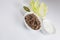 Vertical close up flat lay top view shot of a bowl of sliced beef fillet pieces, a plate of cellophane glass noodles and a cup of