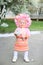 Vertical close-up photo of a little girl with a sprig of blooming cherry in hands