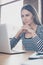 Vertical close up portrait of concentrated minded businesswoman