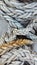 Vertical close-up shot of details of sail rope on the mast of a sailboat. Marine equipment, journey