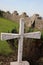 Vertical close-up shot of a stone grave cross