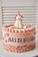 Vertical closeup of a birthday cake with a unicorn on the top and the name Aurelia on it on a plate