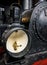 Vertical closeup of a black locomotive headlight