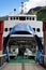 Vertical closeup of an entrance of the large blue-and-white ship moored in the harbor Norway