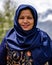 Vertical closeup of a female Hindu Buddhist pilgrim in a traditional dress at Muktinath Temple