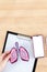 Vertical closeup of the hands holding paper lungs above the clipboard on the table.