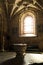 Vertical closeup of an inside view of Jeronimos Monastery with an arched window