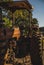 Vertical closeup of a large orange vintage farm tractor sunlit clear sky background