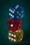 Vertical closeup macro shot of colorful dice stacked on top of each other