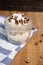 Vertical closeup of a pecan dessert on the wooden table coffee beans, striped tea towel background