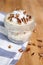 Vertical closeup of a pecan dessert on the wooden table coffee beans, striped tea towel background