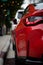 Vertical closeup of a red modern car taillights