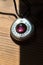 Vertical closeup shot of astrology themed purple necklace on a wooden table under the sunlight