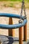 Vertical closeup shot of a children swing on a playground