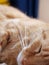 Vertical closeup shot of a cute little ginger cat with long whiskers sleeping indoors