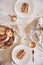 Vertical closeup shot of delicious Nut snails with coffee Cappuccino on the white wood table