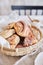 Vertical closeup shot of delicious Nut snails with coffee Cappuccino on the white wood table