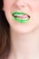 Vertical closeup shot of a female wearing a green lipstick - great for an article about cosmetics