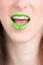 Vertical closeup shot of a female wearing a green lipstick - great for an article about cosmetics