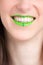 Vertical closeup shot of a female wearing a green lipstick - great for an article about cosmetics