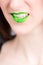 Vertical closeup shot of a female wearing a green lipstick - great for an article about cosmetics