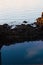 Vertical closeup shot of the fjord with stones at sunset in Trondheim, Norway