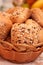 Vertical closeup shot of freshly baked bread covered with various seeds, arranged in a breadbasket