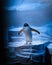 Vertical closeup shot of Gentoo penguin on surface of rock in zoo, by illuminated with blue light