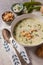 Vertical closeup shot of a green broccoli soup and a spoon