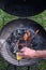 Vertical closeup shot of a hand cleaning a rack on a grill