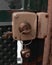 Vertical closeup shot of a key with a keychain hanging from the lock of a metal gate door