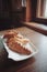 Vertical closeup shot of kibinais from Lithuanian cuisine on a white glassy tray on a wooden table