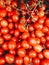 Vertical closeup shot of a lot of red tomatoes - perfect for an article about agriculture