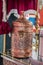 Vertical closeup shot of a metallic antique object with traditional design on a table