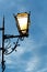 Vertical closeup shot of an old fashioned street lamp in a street of Cadaques, Catalonia at night