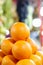 Vertical closeup shot of a pile of juicy oranges