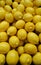 Vertical closeup shot of a pile of lemons at a market