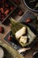 Vertical closeup shot of preparation of rice dumplings with banana leaves